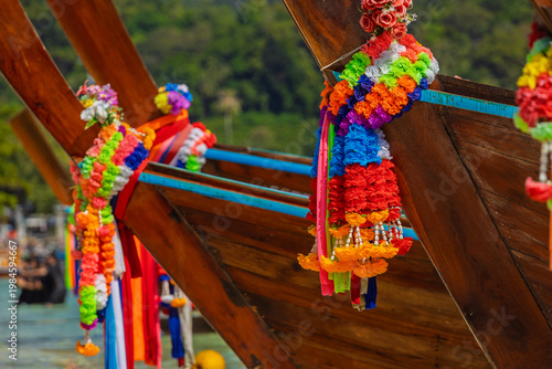 Foto Colorful bright flower garlands on bows of wooden longtail boats, Thailand