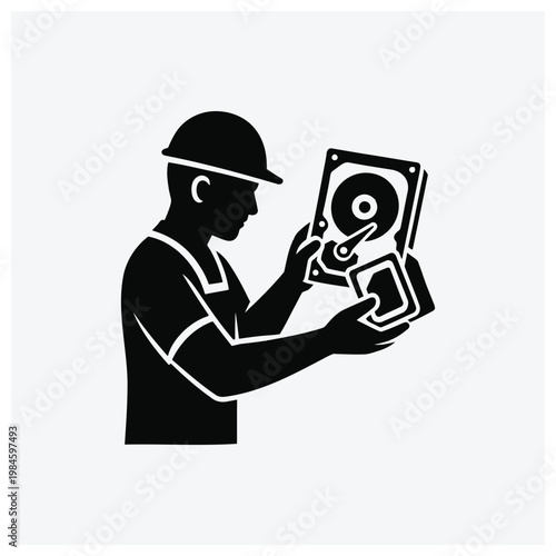 Technician examining hard drive and memory card