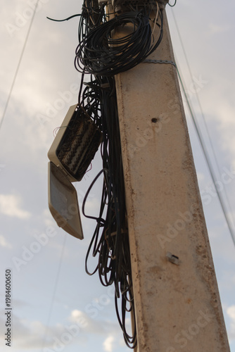 Konstfotografi Tangled power lines and telecommunication cables creating hazardous conditions o