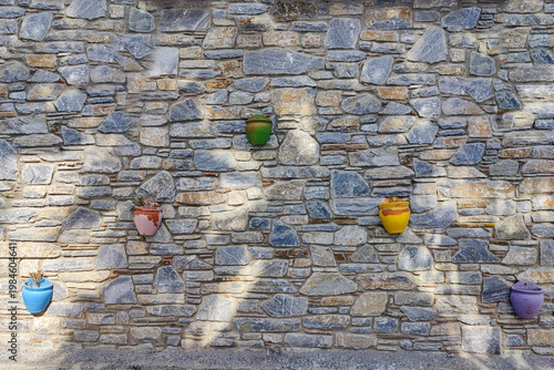 Image of a natural stone wall and the decorations on it.