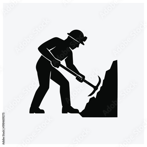 Silhouette of a miner working with a pickaxe