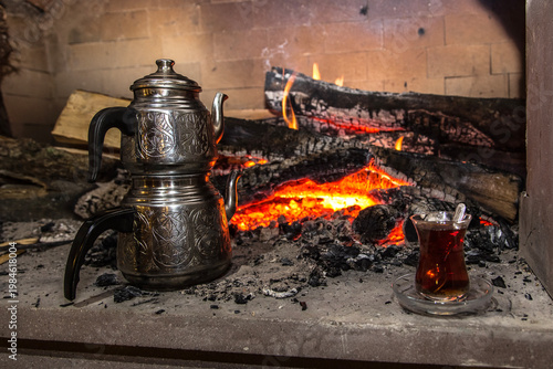Image of campfire, teapots, and teaglass.