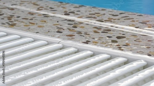 Water flows at the edge of the pool during sunny day