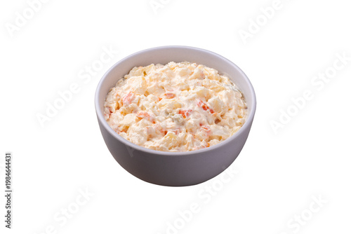 Russian salad or mayonnaise salad in a plate isolated over white background