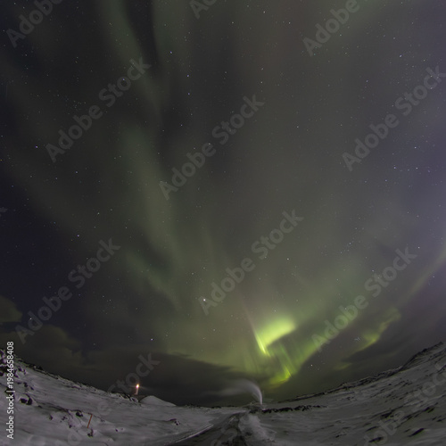 Aurora borealis over lighthouse and geothermal area Reykjanes Iceland