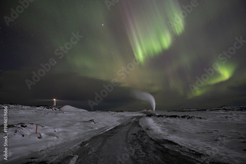 Aurora borealis over Reykjanesviti lighthouse and geothermal vent Iceland