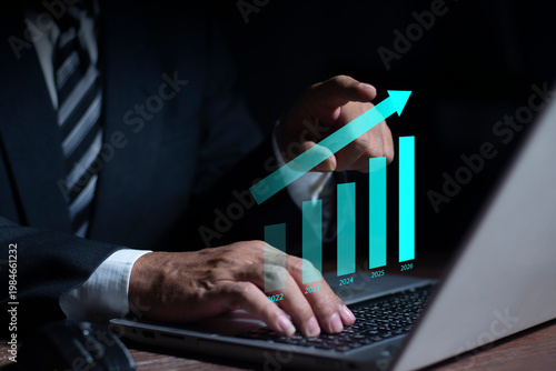 Businessman touching futuristic business growth graph highlighting 2026. Concept of market analysis and investment