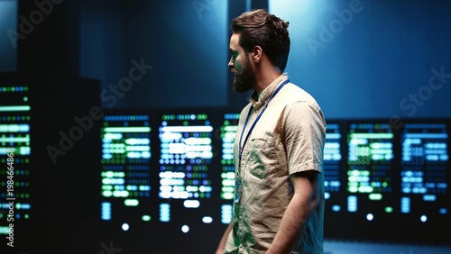 Bild auf Leinwand Engineer walking in server room housing advanced data storage infrastructure sto