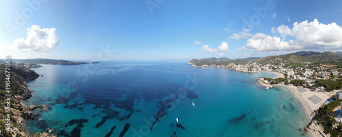 Landscape of the bay of Paguera on the island of Majorca Spain. Impressive scene with turquoise calm waters and bright blue sky. Paguera beaches a long the 