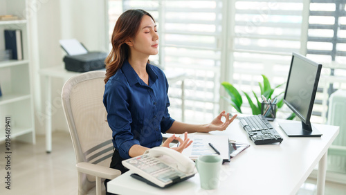 Картината върху платно Serene Office Meditation: An Asian woman finds inner peace through meditation at her workspace, balancing work with wellness