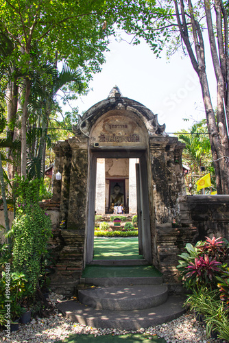 Ancient gate entrance of antique temple Wat Nang Pluem for thai people traveler visit and respect praying blessing buddha worship in Ayutthaya province, Thailand.