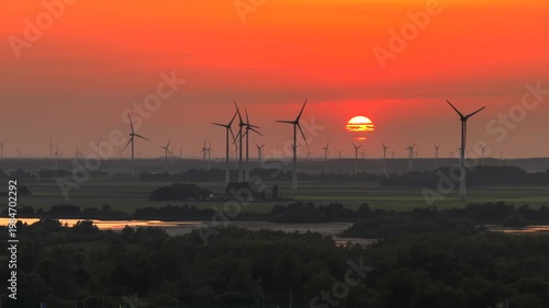 Colorful Sunset with Wind Turbines in the Netherlands. Sustainability, Modern and Renewable energy. Red Sky Aerial Shot.