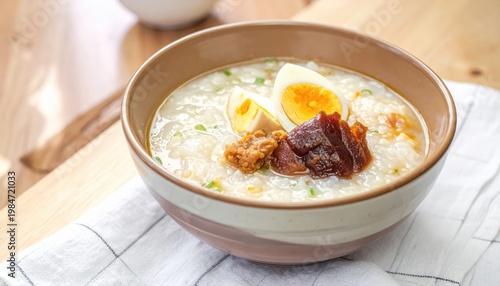 Hearty Congee and Savory Toppings in a Ceramic Bowl: A Delicious and Comforting Asian Breakfast or Meal.