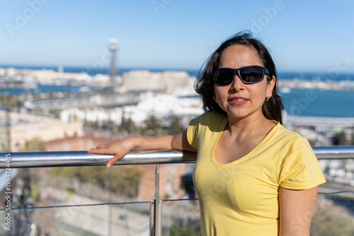 Latin woman enjoying city views and vacation during a trip to Barcelona, Spain