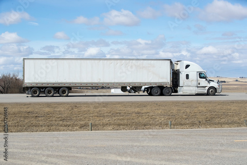 Heavy Cargo on the Road. A truck transporting cargo along a highway. Taken in Alberta, Canada