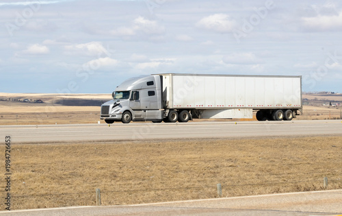 Heavy Cargo on the Road. A truck transporting cargo along a highway. Taken in Alberta, Canada