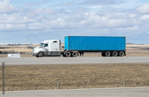 Heavy Cargo on the Road. A truck transporting cargo along a highway. Taken in Alberta, Canada