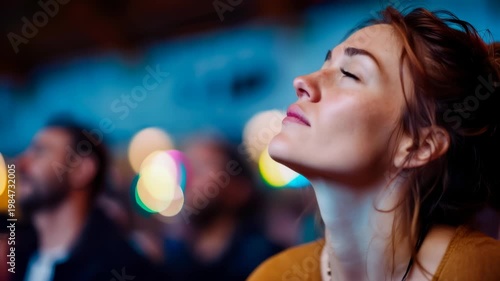 Thoughtful young woman looking upward in colorful light with calm spiritual and reflective mood