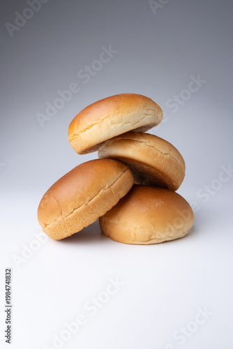 Fresh hamburger buns on a clean background, highlighting soft texture and golden crust in a simple bakery composition ideal for food, fast food, and culinary concepts.