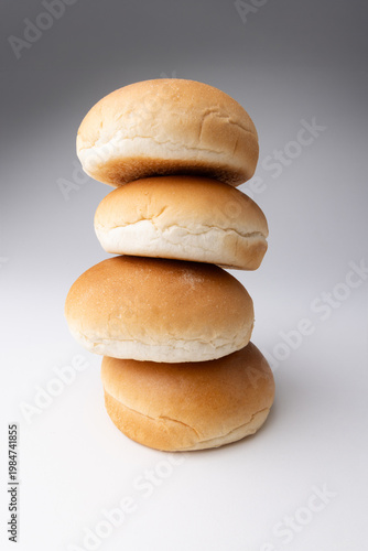 Fresh hamburger buns on a clean background, highlighting soft texture and golden crust in a simple bakery composition ideal for food, fast food, and culinary concepts.
