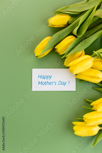 fresh yellow tulips floral border on green backdrop