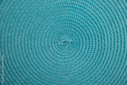 Turquoise braided circular woven textile surface for vibrant decorative home decor