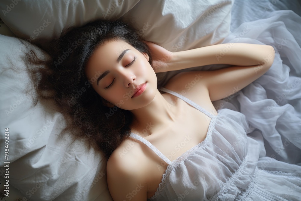 Naklejka premium Woman resting comfortably on soft white linen, enjoying a peaceful sleep