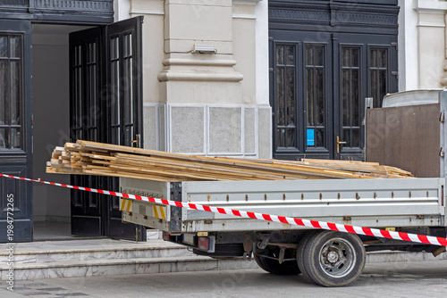 Lumber Delivery Truck in Front of Building Doors Construction Site