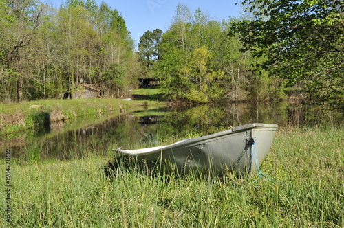 boat by pond in rural setting