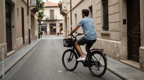 Young Man Cycling Down a Quiet Urban Street in Summer Morning Light