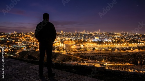 Silhouette of a Person Overlooking Jerusalem at Night with City Lights