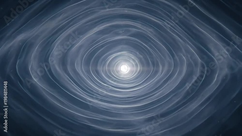 A mesmerizing swirling light forms concentric circles in a dark space.