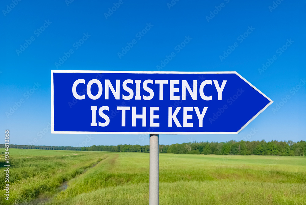 Obraz premium Consistency is the key symbol. Concept words Consistency is the key on beautiful blue road sign. Beautiful blue sky green field background. Business consistency is the key concept. Copy space.