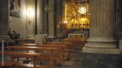 Photos Soft defocused church interior with warm candlelit altar, empty wooden pews, stone columns and distant gilt reredos in shallow bokeh church; background backdrop copyspace calm