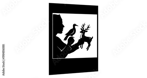 Childs hand with bird and deer puppets against bright light silhouette
