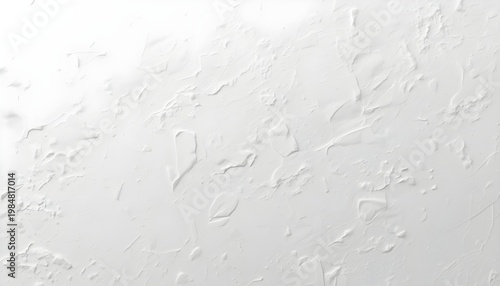 A close-up view of a white textured surface with a rough, bumpy finish