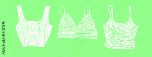 Spring Fashion Collection of Female Tops Hanging on a Clothesline Including Corset Crop Top Lace Bralette and Floral Camisole in White on Fresh Green Background