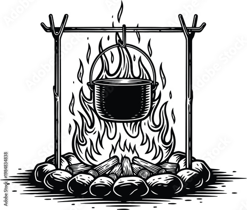 Campfire cooking pot suspended over flames and rocks with wood burning during nighttime outdoors