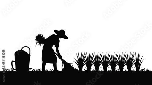 A silhouetted farmer tending to a small rice paddy field with tools