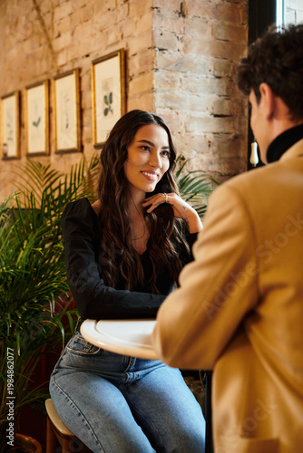 Fotografie Couple celebrating love in a cozy restaurant setting