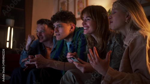 Group Of Friends Passionately Cheer While Playing Video Games With Snacks And Controllers
