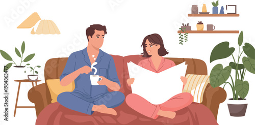 Couple in pajamas relaxing on sofa drinking coffee, reading book, home interior comfort lifestyle.