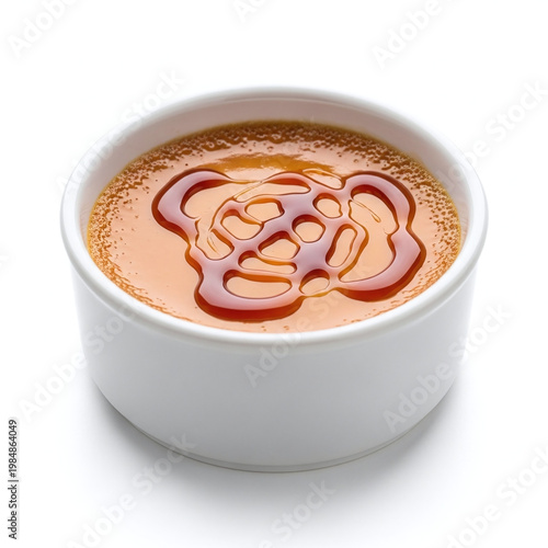 Caramel sauce in white cup isolated on white background