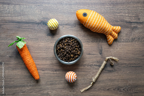 Cat food bowl and toys flat lay pet care feeding and play concept