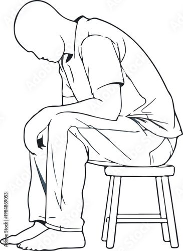 Man sitting on stool head down looking dejected and sad.