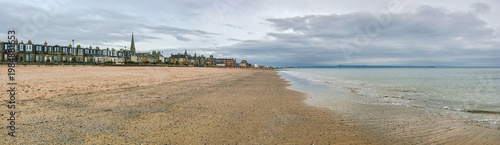 Empty east end of Portobello beach in Edinburgh, overcast autumn day, Joppa parish church tower visible at distance