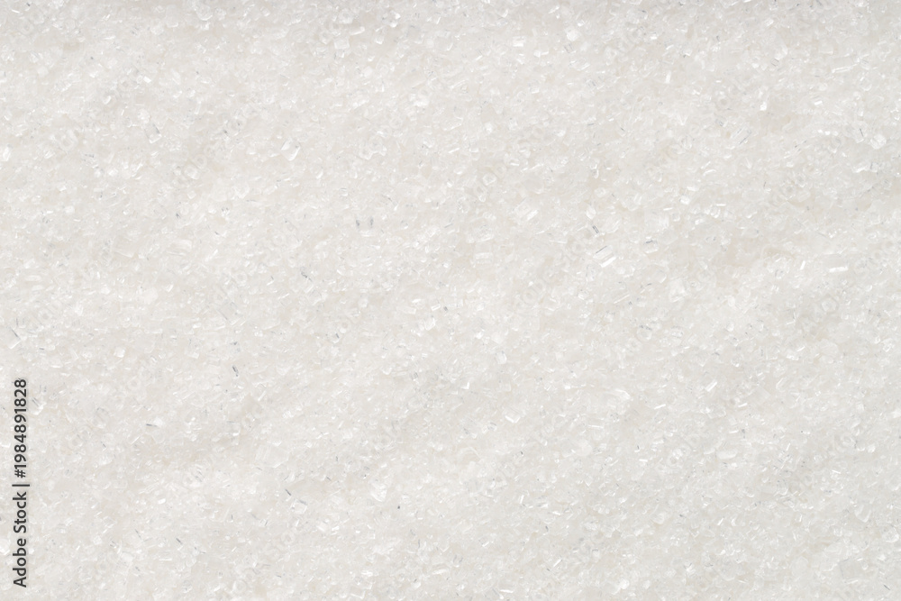 Naklejka premium White granulated sugar as background, top view
