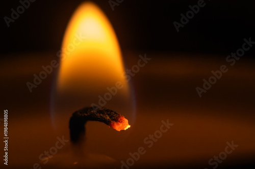 burning match on a dark background