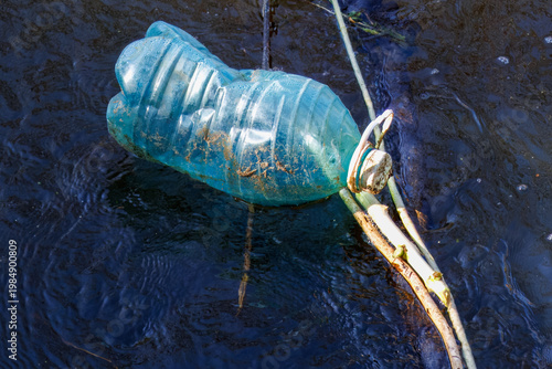 A plastic bottle in the river.