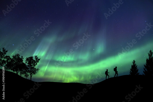 Obraz na plátně A person is observing a magnificent Aurora Borealis light display in an open field Success concept